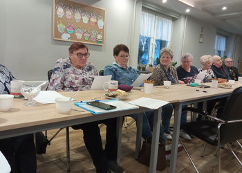 zdjęcie przedsawia seniorów podczas wieczoru poetyckiego 